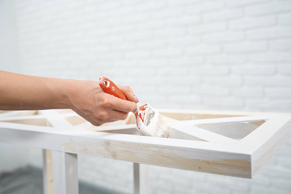 960 close up female hands painting wooden rack